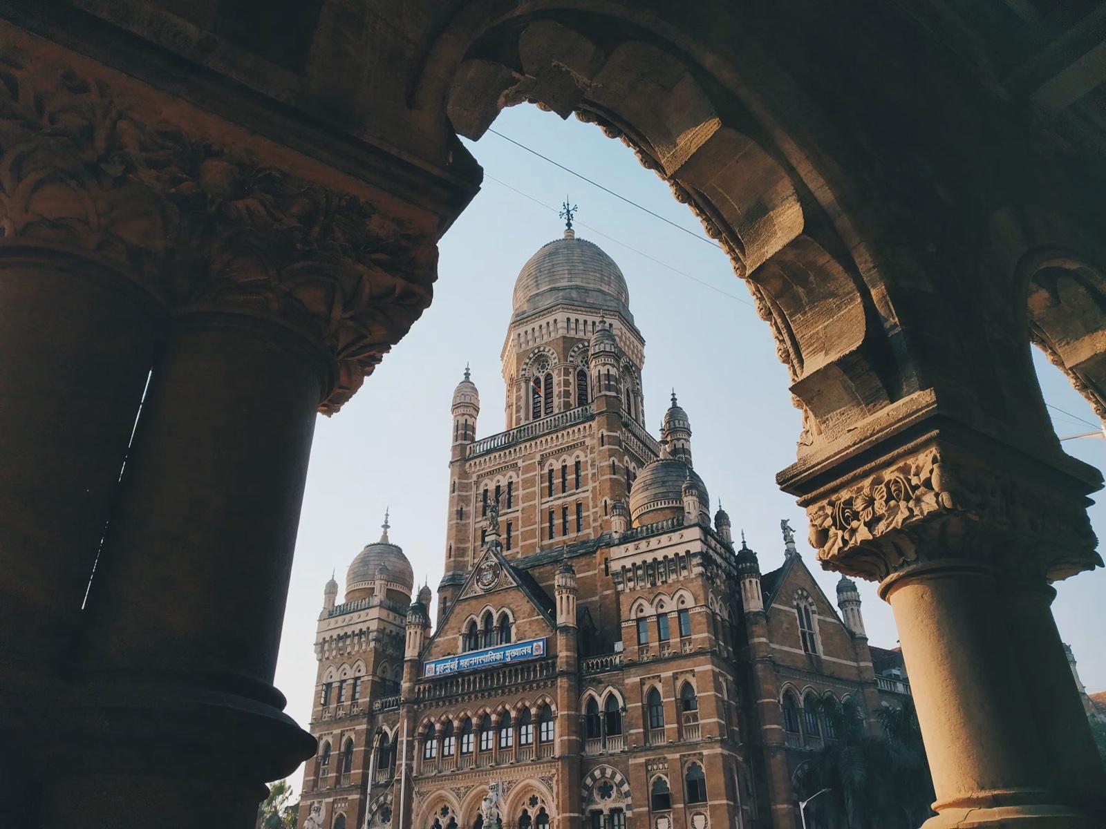 Chhatrapati Shivaji Maharaj Terminus seen through a stone archway